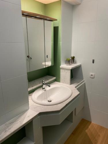 a bathroom with a sink and a mirror at Ferienwohnung Weiding in Rutzenmoos
