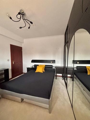 a bedroom with a large bed with yellow pillows at Apartmán Ela in Komárno
