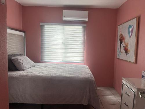 a bedroom with a bed in front of a window at serenity in Fajardo