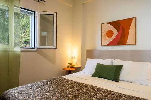a bedroom with a bed and a window at Vrachos Nature Lodges Thyme 1, Private pool in Agia Galini