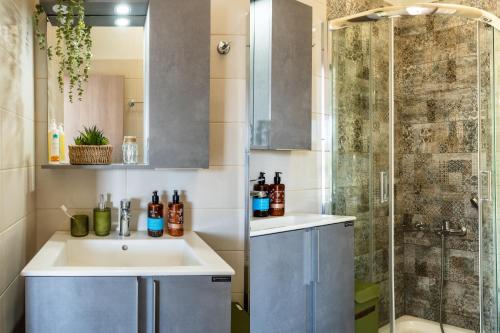 a bathroom with a sink and a shower at Vrachos Nature Lodges Thyme 1, Private pool in Agia Galini