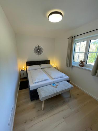 a bedroom with a bed and a bench in it at Villa Lidl Ferienwohnung in Altaussee