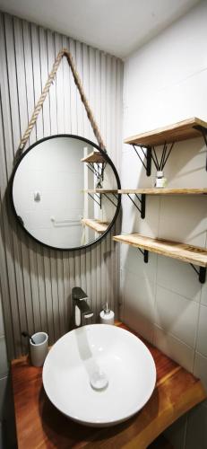 a bathroom with a white sink and a mirror at Apartamento Termas de Chillán in Nevados de Chillan