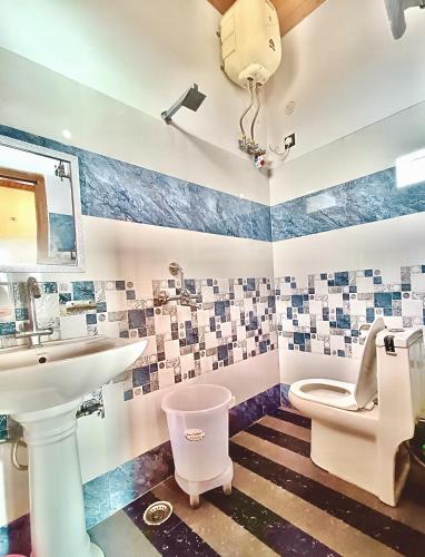 a bathroom with a sink and a toilet at Anurag Hotel Chakrata in Chakrāta