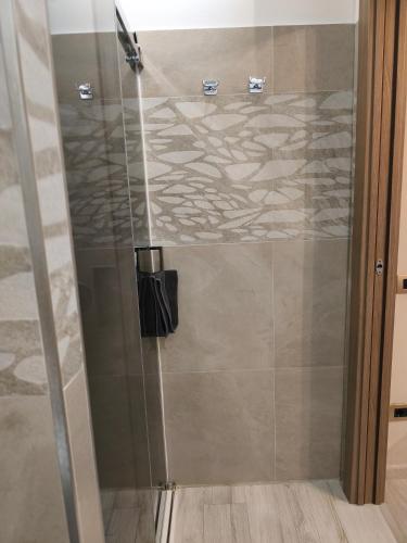 a shower with a glass door in a bathroom at Casa Ramalma Estate in Brianza Appartamento tra Milano Monza e Como con self check-in in Seveso
