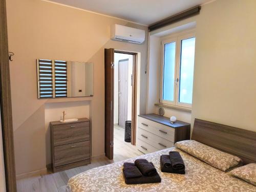a bedroom with a bed and a dresser and a sink at Casa Ramalma Estate in Brianza Appartamento tra Milano Monza e Como con self check-in in Seveso