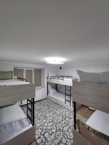 a room with two beds and a room with bunk beds at BridgeStayHostel in Samarkand