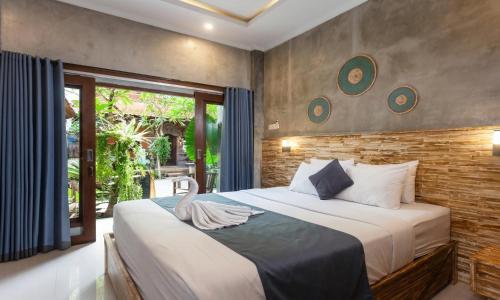 a bedroom with a large bed and a window at Rumah Weda in Ubud