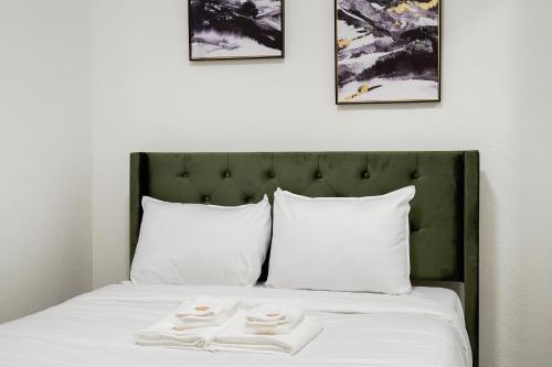a bed with white sheets and two towels on it at Cozy Affordable Private Rooms Newly Renovated near SF Transportation in San Francisco
