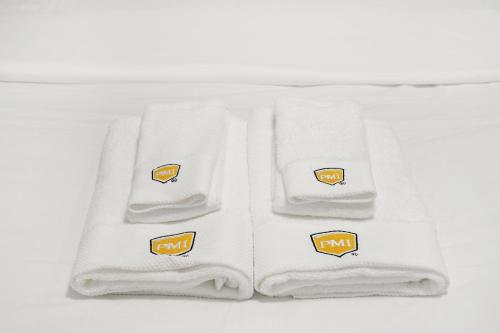 four white towels with orange and yellow stickers on them at Cozy Affordable Private Rooms Newly Renovated near SF Transportation in San Francisco