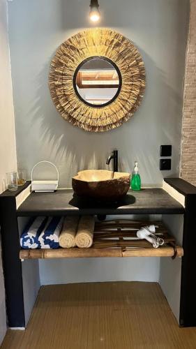 a bathroom with a sink and a mirror at Café Gili Beach Bungalows in Gili Meno