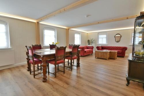a living room with a table and chairs and a couch at Ferienwohnung Harmony "Residenz" in Leisnig