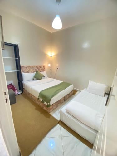 a bedroom with two beds in a room at Dakhla sky blue in Dakhla