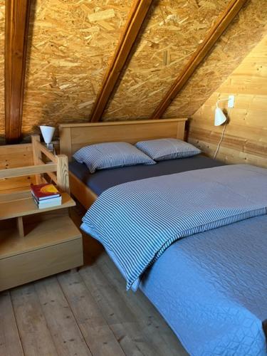 a bedroom with two beds in a wooden room at Apartmani Milekić in Mokra Gora