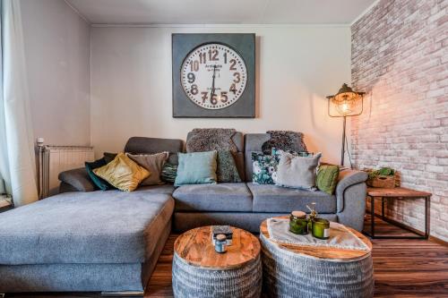 a living room with a couch and two ottomans at Hisa Lina near Bovec in Srpenica