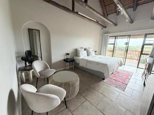a bedroom with a bed and a table and chairs at The Hide on 37 Flamingo in East London
