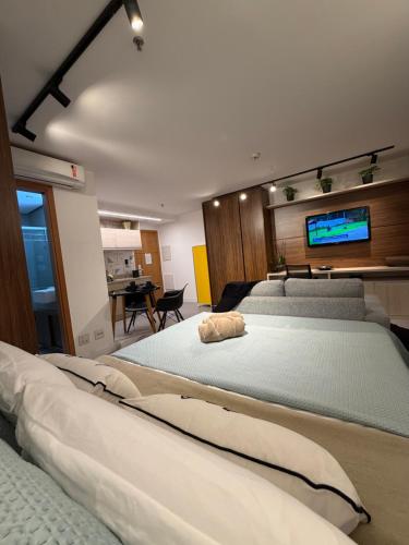 a bedroom with two beds and a flat screen tv at 710 A Hotel Home Jade in Brasília