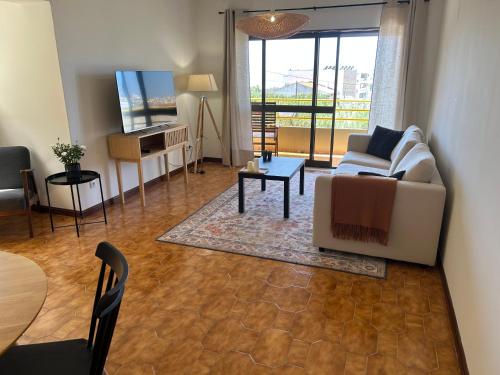 a living room with a couch and a table at The Urban Terrace in Figueira da Foz