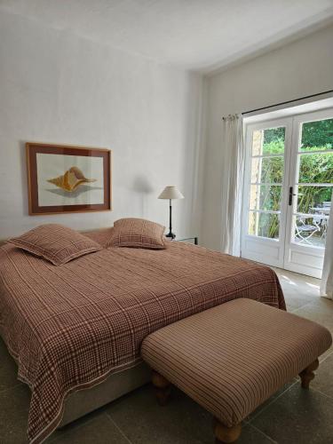 a bedroom with a large bed and a window at La Ribaude in Crestet