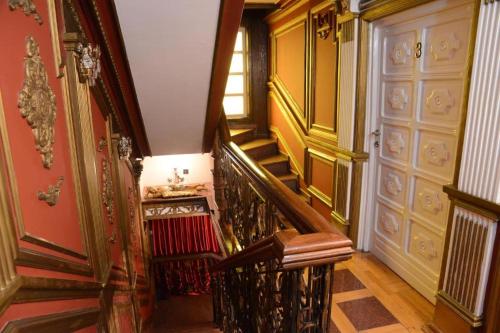 a hallway with a spiral staircase in a house at Guest House Vivaldi in Niš