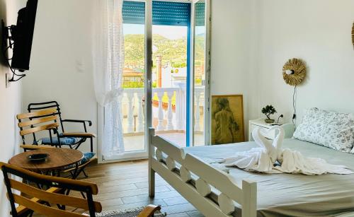 a bedroom with a bed and a balcony at Ekati in Xylokastro