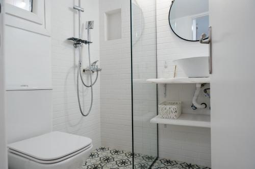 a bathroom with a shower and a toilet and a sink at Ekati in Xylokastro