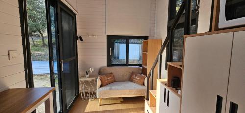 a small room with a chair in a tiny house at Tiny house avec jacuzzi in Cadenet