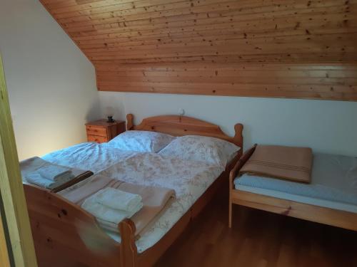 a bedroom with a bed and a wooden ceiling at Apartment Zorc in Trenta