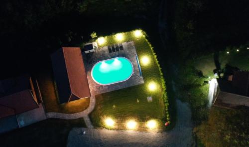 an overhead view of a large apple sign at night at Holiday Home BIBA With Heated Outdoor Pool in Gornja Stubica