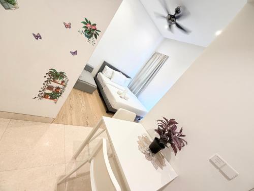 a white living room with a couch and a table at Lucentia residence luxury suites in Kuala Lumpur