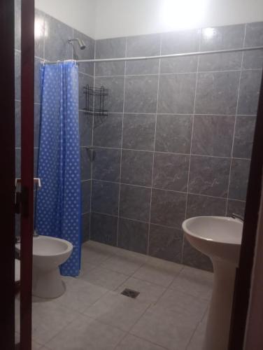 a bathroom with a sink and a toilet and a shower at Hospedaje Ayla in Tinogasta