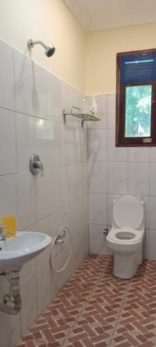 a bathroom with a toilet and a sink at Perfect Backpacker Spot in Shimoni
