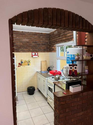 a kitchen with a stove and a counter top at Casa Mitre in Luján