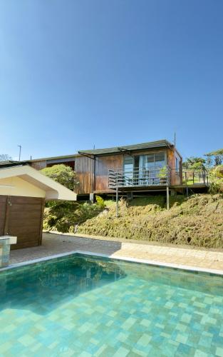 a house with a swimming pool in front of a house at Paulos View Lodge in Colonia