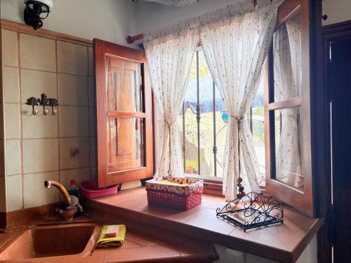 a kitchen with a sink and a window with a view at Finca Las Polinarias Casa Cueva en Fasnia in Santa Cruz de Tenerife