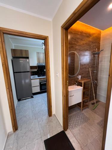 a kitchen with a refrigerator and a sink at Dar anas in Fafou