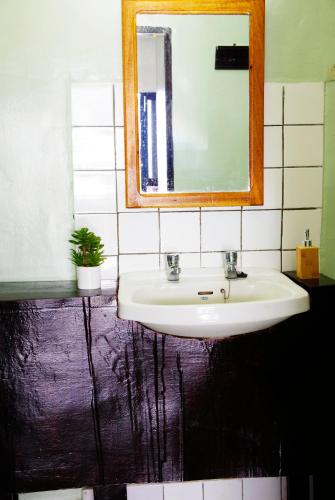 a bathroom with a sink and a mirror at Spa Elpis in Kigali