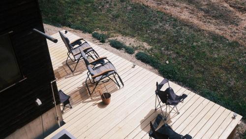 an overhead view of two chairs and a table at OKANiWA 丘庭 in Nagiso