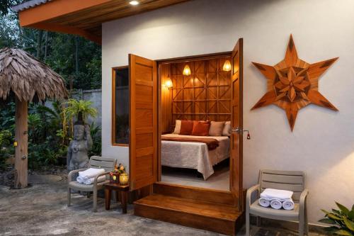 a bedroom with a bed and a star on the wall at Sanctuary Puerto Viejo in Cocles