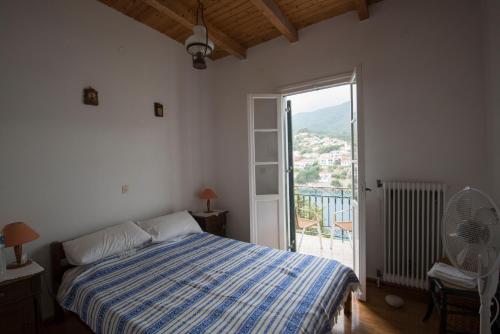 a bedroom with a bed and a large window at Costa's House in Kiónion