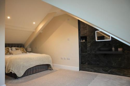 a bedroom with a bed and a stone wall at Modern 2 Bed 2 Bath Apartment in Prime Jesmond Location in Newcastle upon Tyne