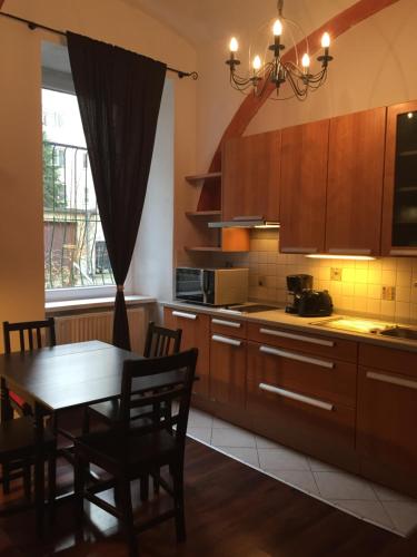 a kitchen with a table and a dining room at Vienna Top Comfort Apartment in Vienna