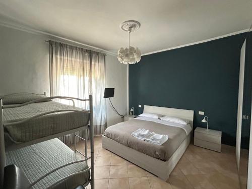 a bedroom with two beds and a green wall at Casa Palma in Rho