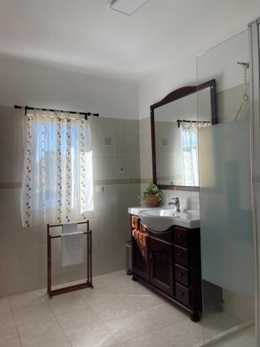 a bathroom with a sink and a mirror at Lagoa House Albufeira in Lagoa de Albufeira