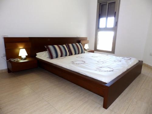 En eller flere senge i et værelse på Apartamentos Medano - Oeste