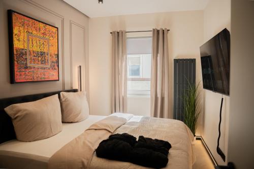 a bedroom with a white bed with a window at ART&SPA Koblenz in Koblenz