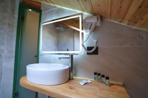a bathroom with a sink and a mirror at Alchemist Inn in Gjirokastër