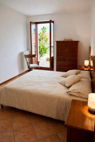 a bedroom with a large bed and a dresser at Il nido di Lera in Lenno
