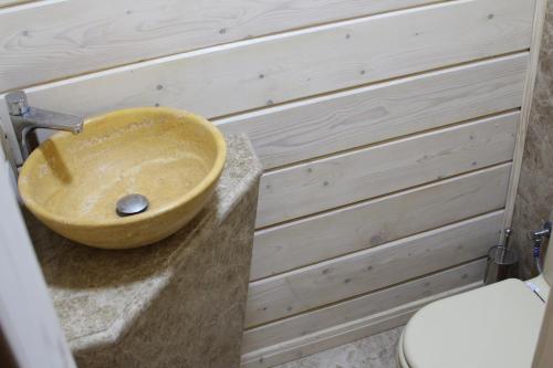 a bathroom with a wooden sink on a counter at Villa Kaiser in Lviv
