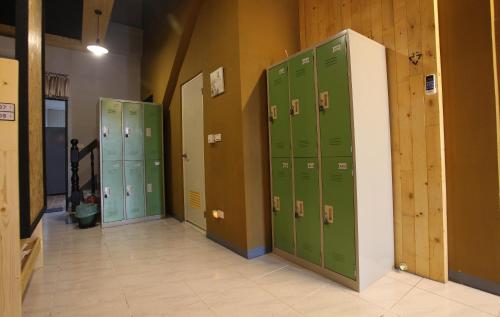 a row of green lockers in a room at Light Shadow in Budai